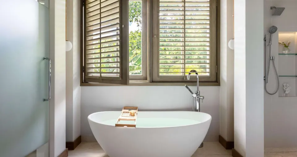 Freestanding soaking tub and shower in a Shore House Butler Suite at Sandals Halcyon.