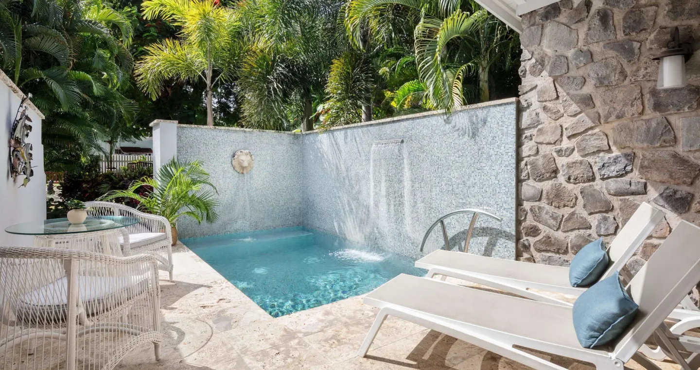 Private plunge pool patio with loungers at a honeymoon room at Sandals Halcyon.