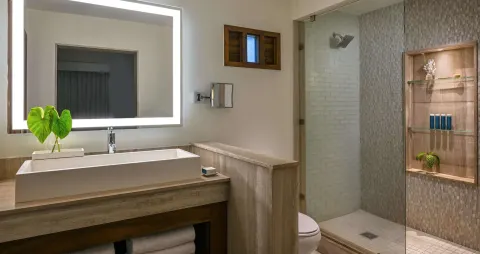 Luxury Room bathroom vanity and glass shower at Sandals Halcyon.