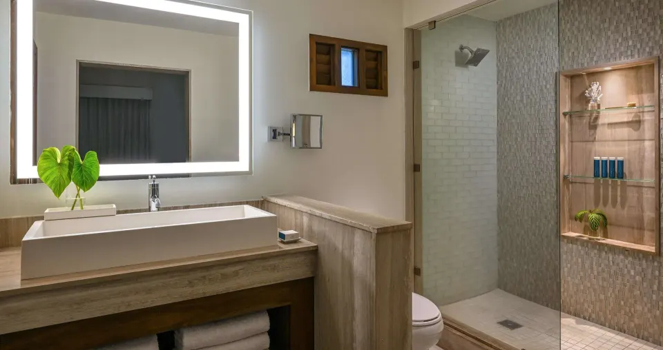 Luxury Room bathroom vanity and glass shower at Sandals Halcyon.