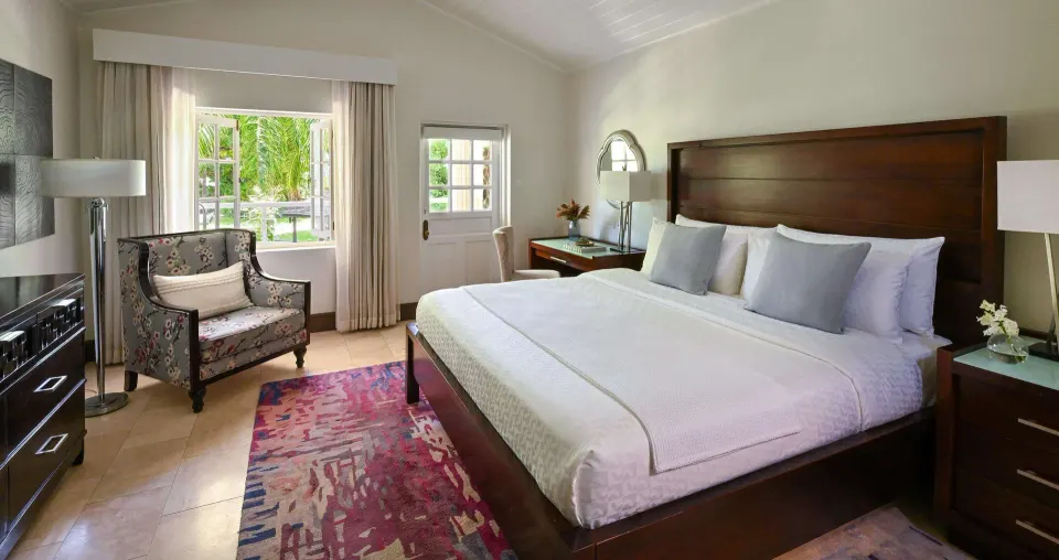 Luxury Room with king bed and garden-facing window at Sandals Halcyon.