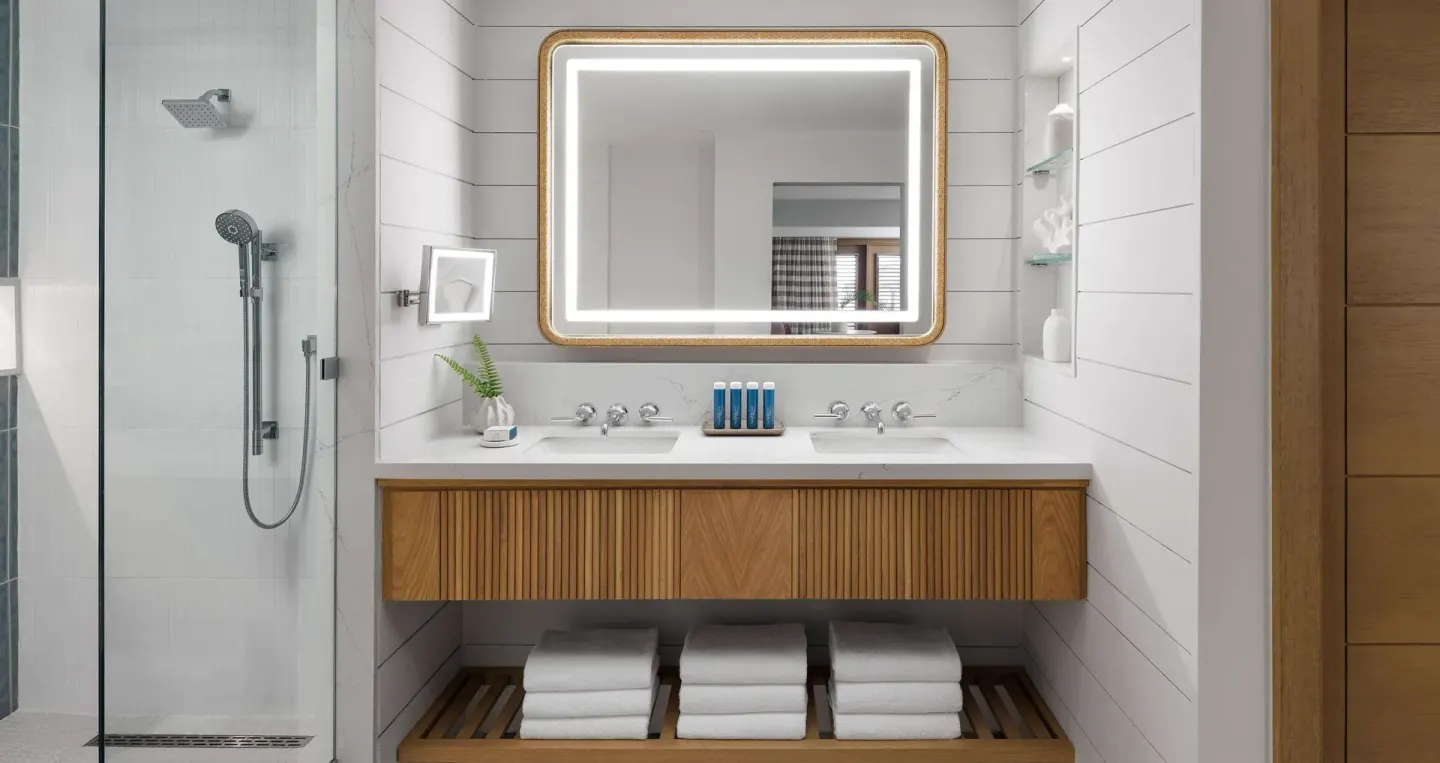Bathroom with double vanity and glass shower at Sandals Montego Bay.