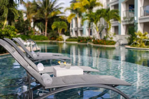 In-water loungers with drinks beside a lagoon pool at Sandals Montego Bay.