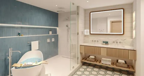 Modern bathroom with freestanding tub and glass shower at Sandals Montego Bay.
