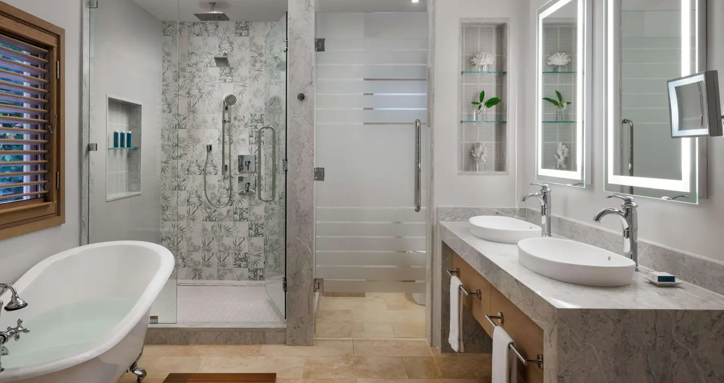 Bathroom with soaking tub, double sinks, and walk-in shower at Sandals Montego Bay.