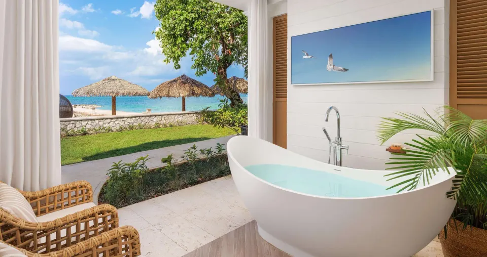 Outdoor soaking tub in a beachfront butler villa junior suite at Sandals Montego Bay.