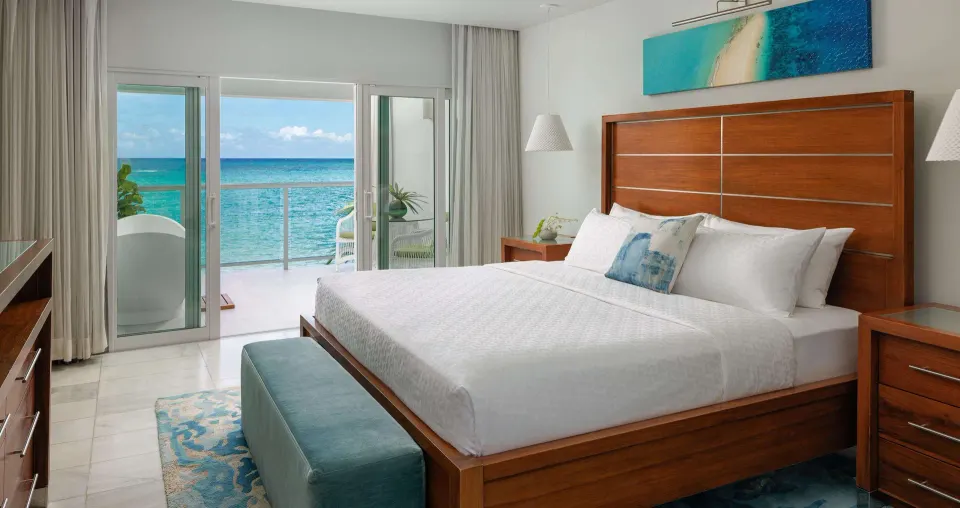 Club Penthouse ocean-view bedroom with balcony at Sandals Montego Bay.