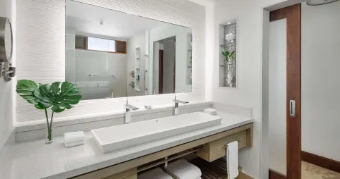 Bright bathroom vanity with wide mirror and vessel sink at Sandals Montego Bay.