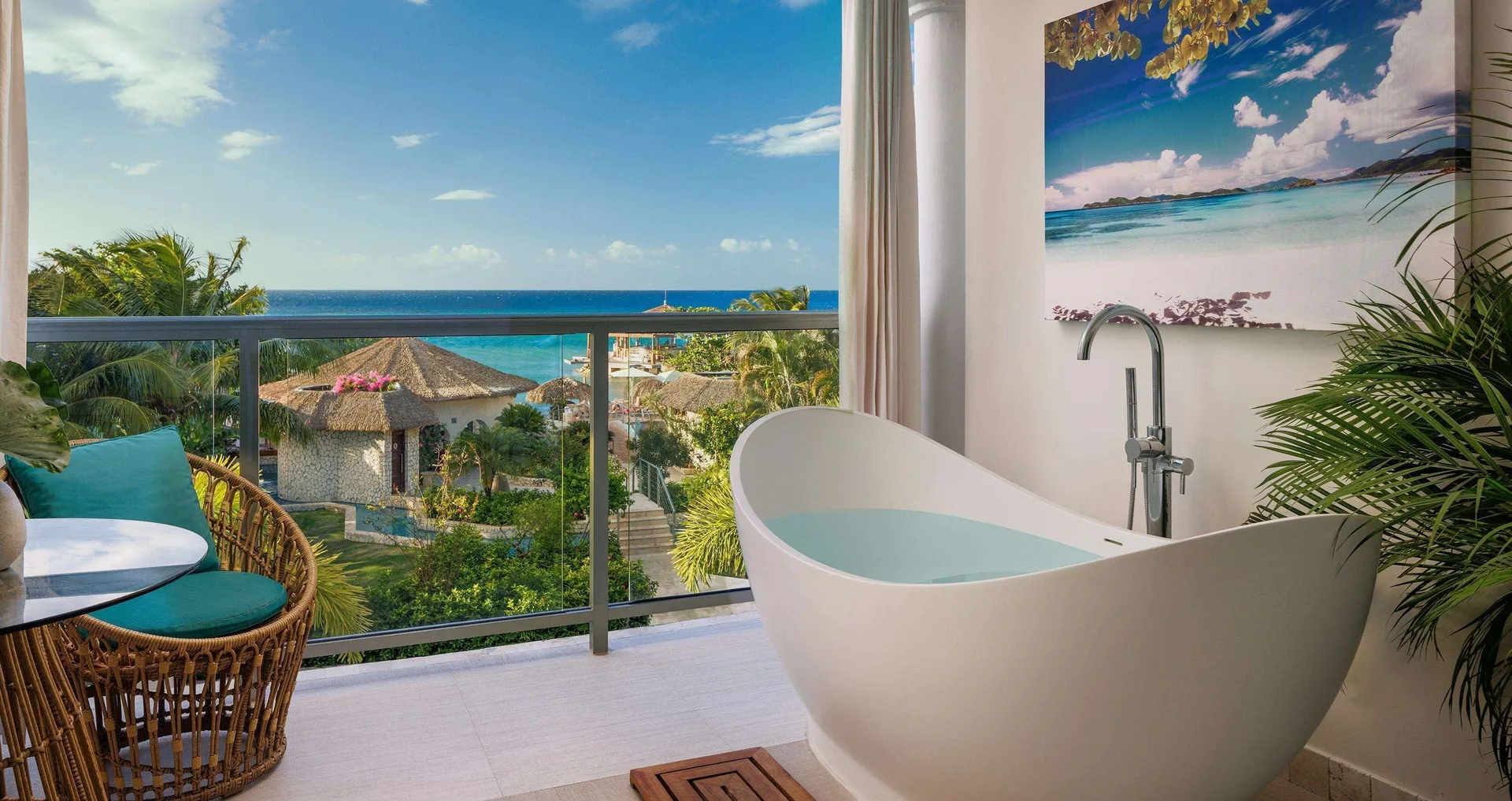 Balcony soaking tub with ocean view from a honeymoon room at Sandals Montego Bay.