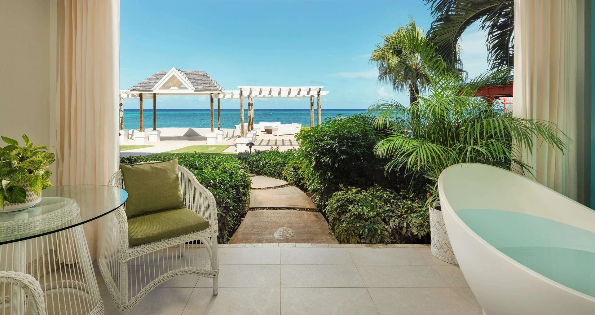 Oceanfront walkout patio with soaking tub and sea view at Sandals Montego Bay.