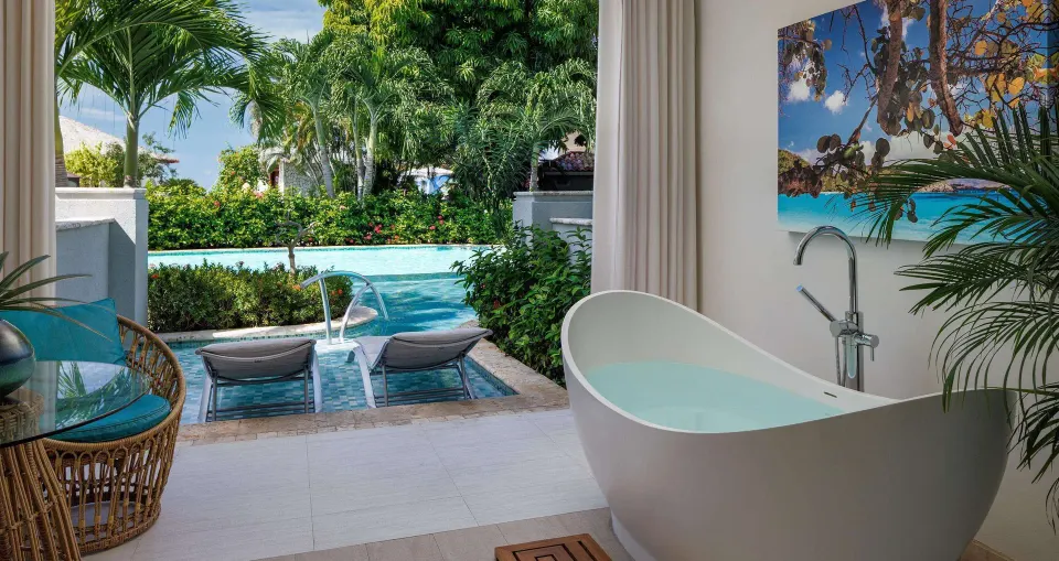 Luxury swim-up room terrace with soaking tub and pool access at Sandals Montego Bay.