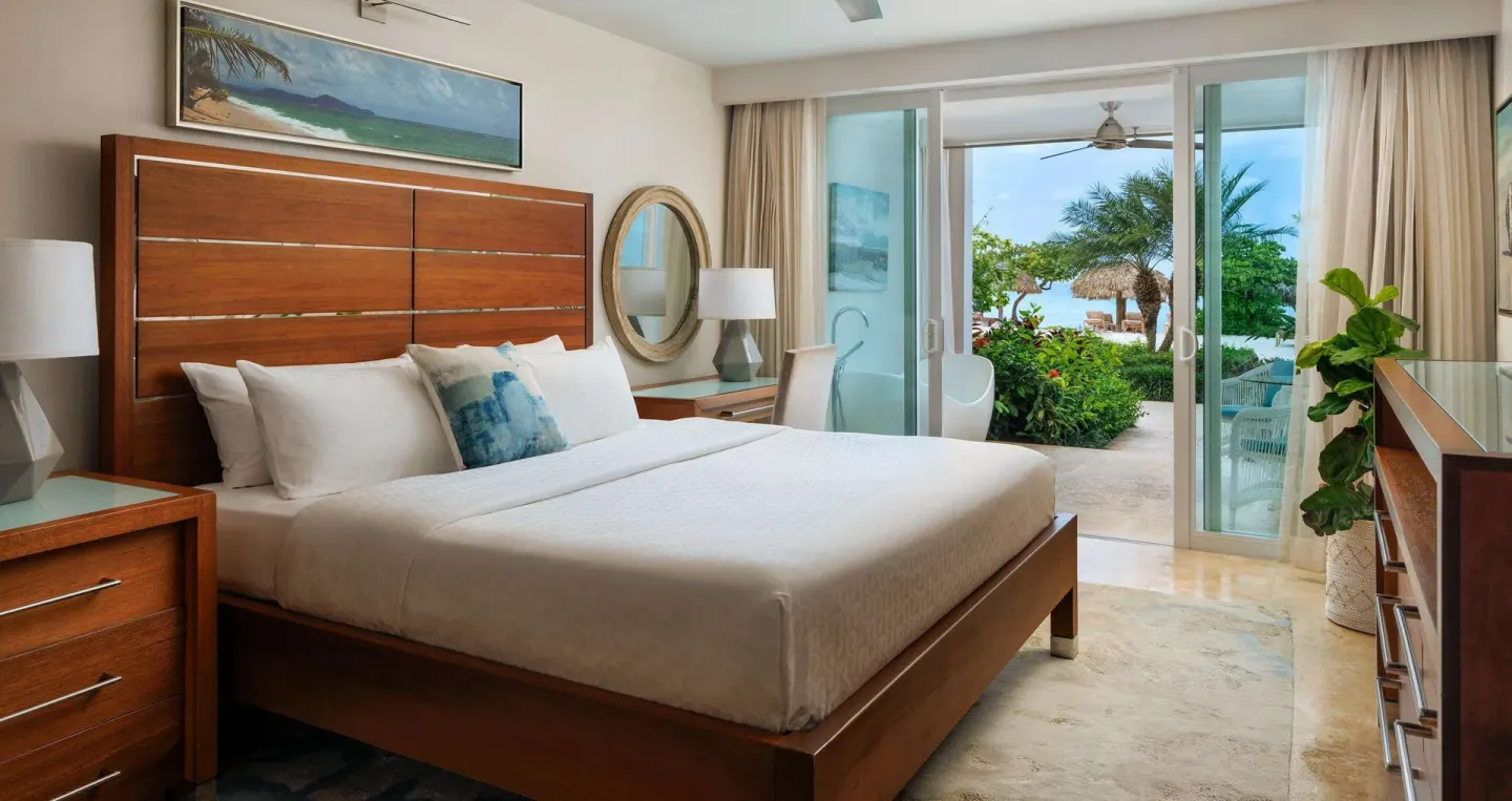 Ocean-view king bedroom in a beachfront luxury suite at Sandals Montego Bay.