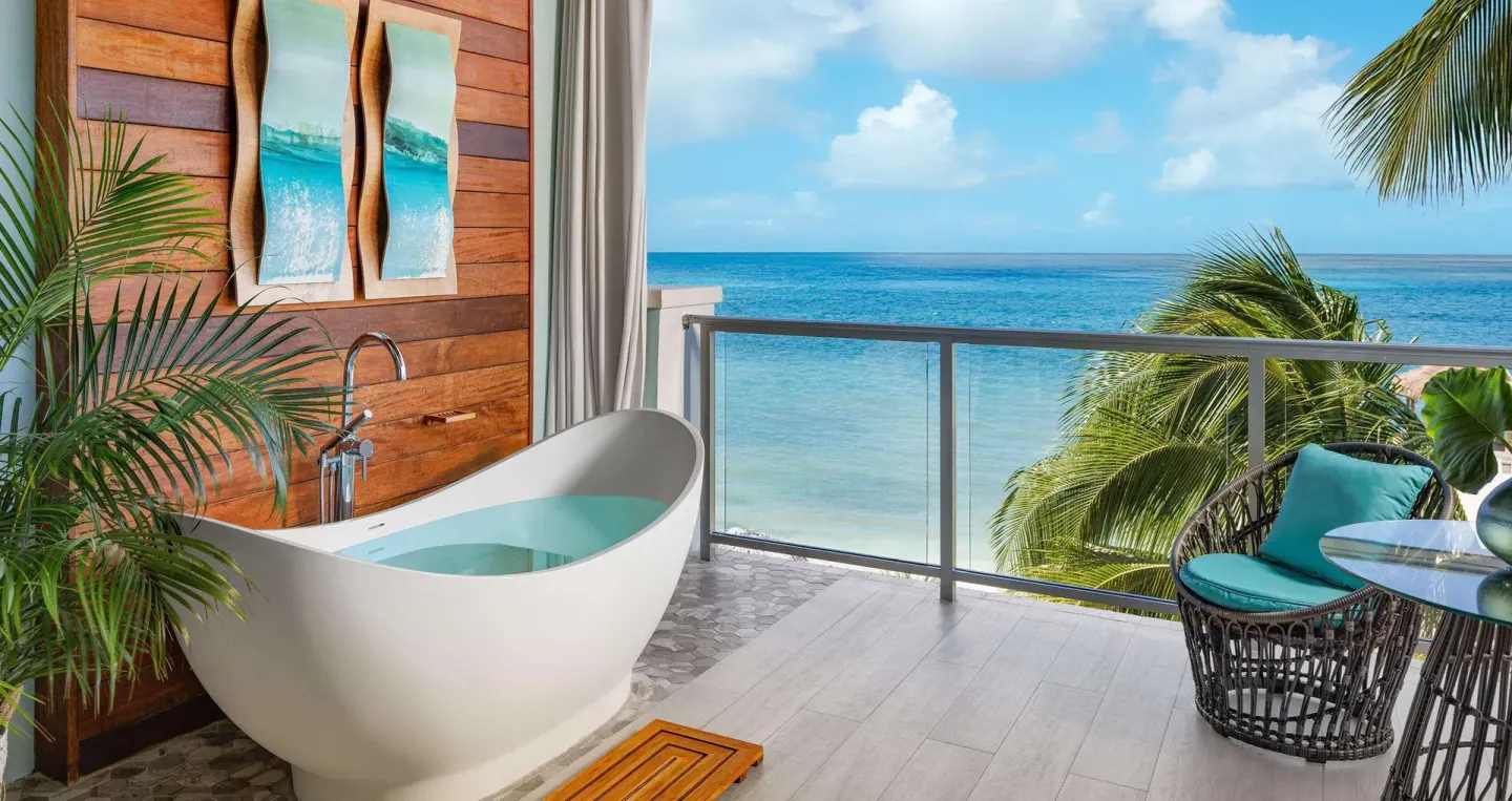 Balcony soaking tub with ocean view at Sandals Montego Bay.