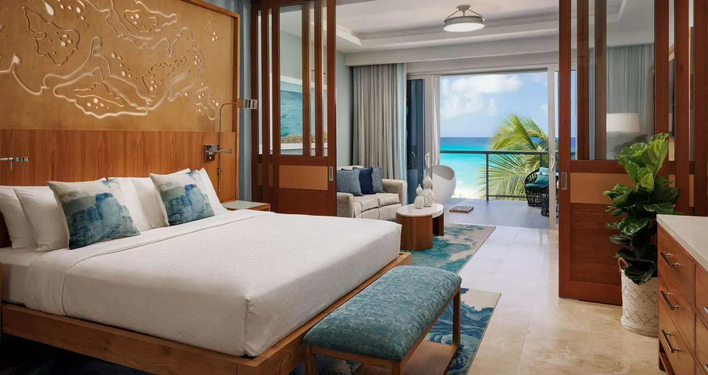 Beachfront one-bedroom suite with king bed and balcony at Sandals Montego Bay.