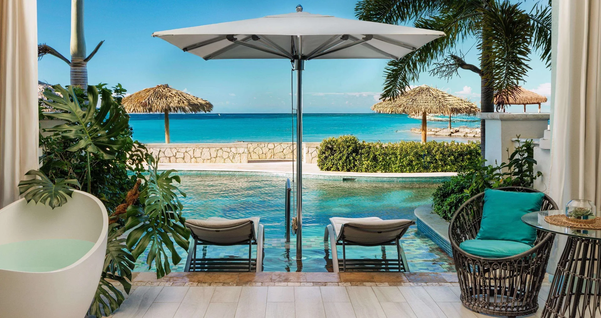 Beachfront swim-up terrace with soaking tub and ocean view at Sandals Montego Bay.