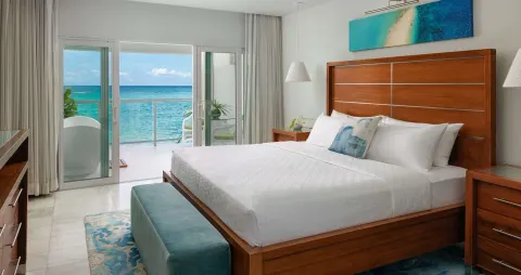 Oceanfront honeymoon room with king bed and balcony at Sandals Montego Bay