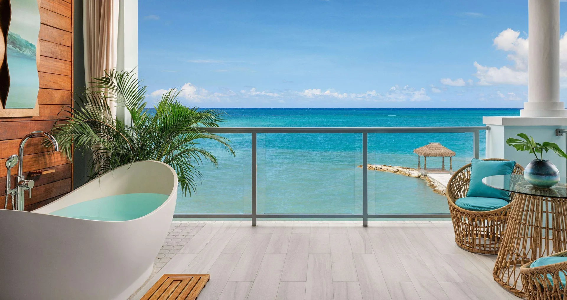 Beachfront suite balcony with soaking tub and ocean view at Sandals Montego Bay.