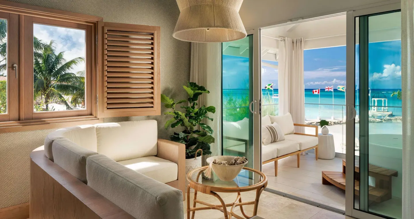 Beachfront suite sitting area and balcony soaking tub at Sandals Montego Bay.