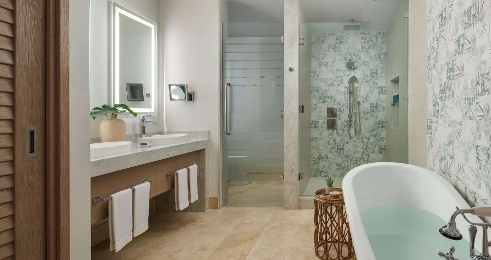 Suite bathroom with vanity, shower, and bathtub at Sandals Montego Bay.