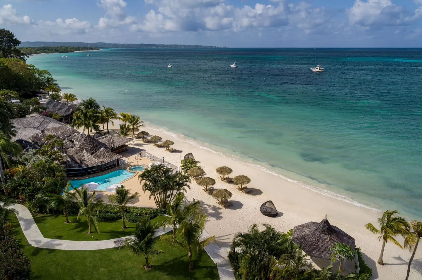 Elevated view of the beach, pool, gardens, and Caribbean Sea at Sandals Negril.