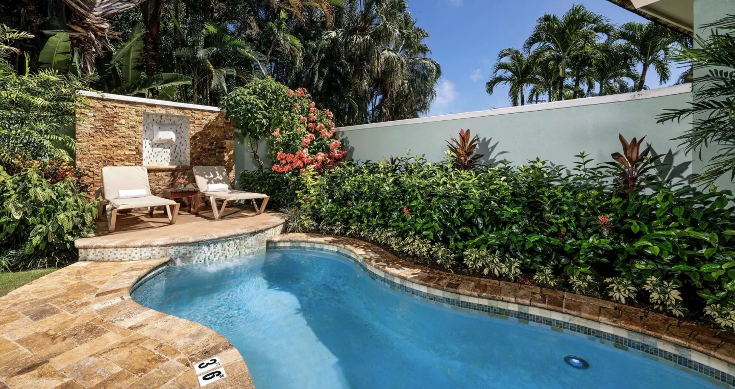 Curved private plunge pool with loungers and tropical landscaping at Sandals Negril.