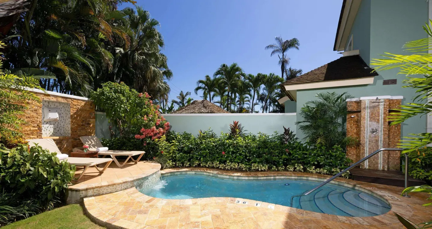 Private plunge pool with steps, loungers, and outdoor shower at Sandals Negril.