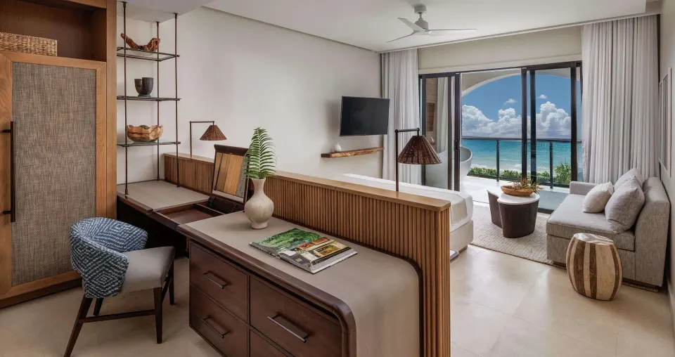 Bamboo Grove club suite with king bed, sitting area, balcony and ocean view at Sandals Negril.