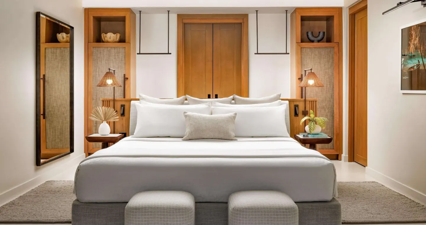 King bed in a Bamboo Grove Skypool suite bedroom at Sandals Negril.