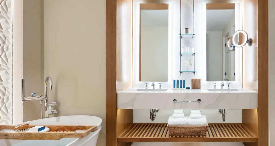Bamboo Grove Swim-Up Club Suite bathroom vanity and tub at Sandals Negril.