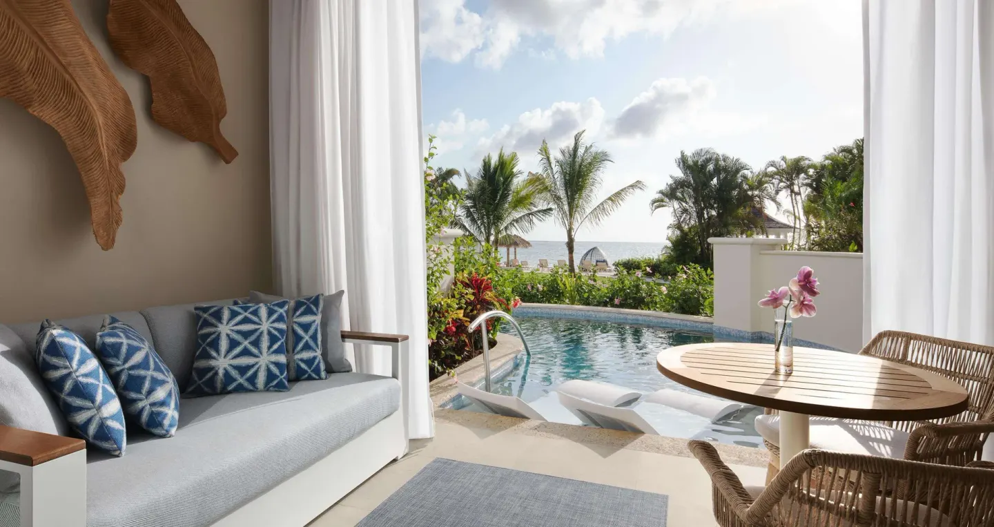 Bamboo Grove Swim-up Club Suite lounge opening to a swim-up pool at Sandals Negril.