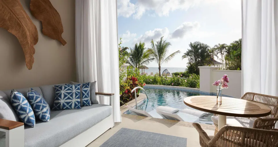 Bamboo Grove Swim-up Club Suite lounge opening to a swim-up pool at Sandals Negril.