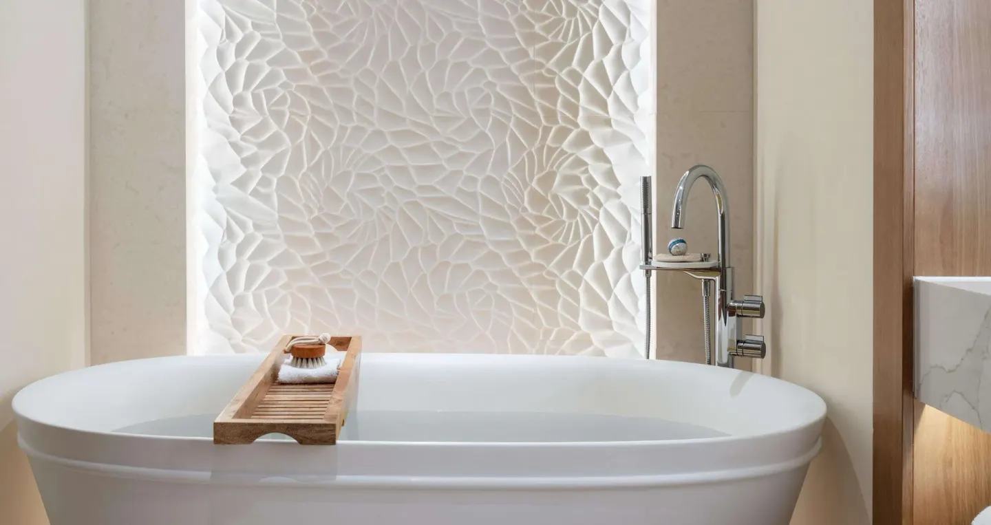 Bamboo Grove Swim-up Club Suite soaking tub with textured wall at Sandals Negril.