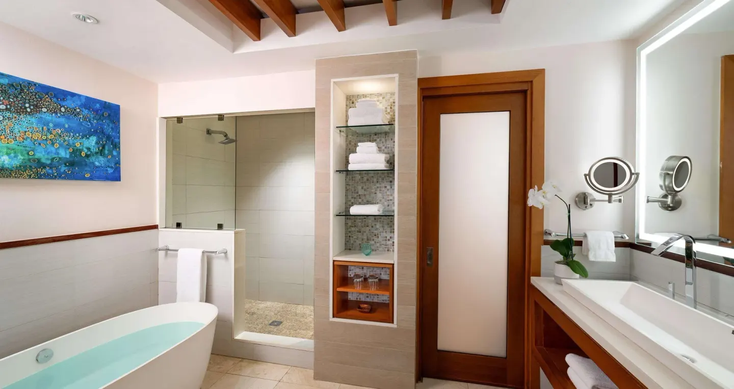 Bathroom with tub, glass shower and double vanity at Sandals Negril.