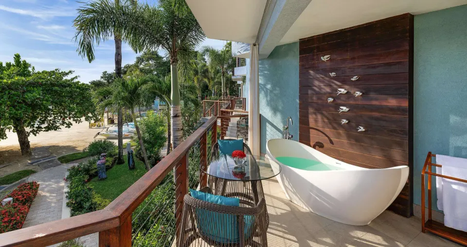 Beachfront balcony with soaking tub and seating at Sandals Negril.