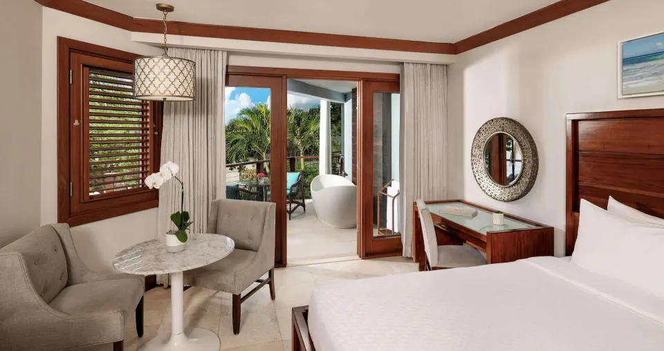 King bedroom with balcony soaking tub outside at Sandals Negril.