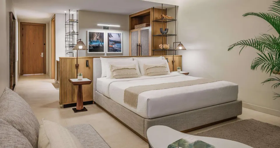 Modern king bed guest room with open vanity area at Sandals Negril.