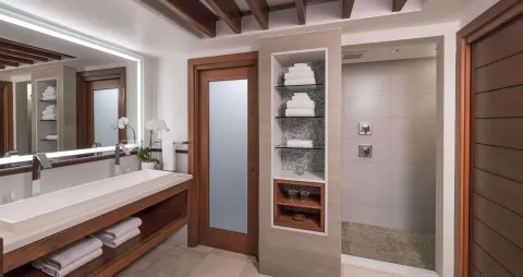 Longshore Luxury Room bathroom with vanity and walk-in shower at Sandals Negril.
