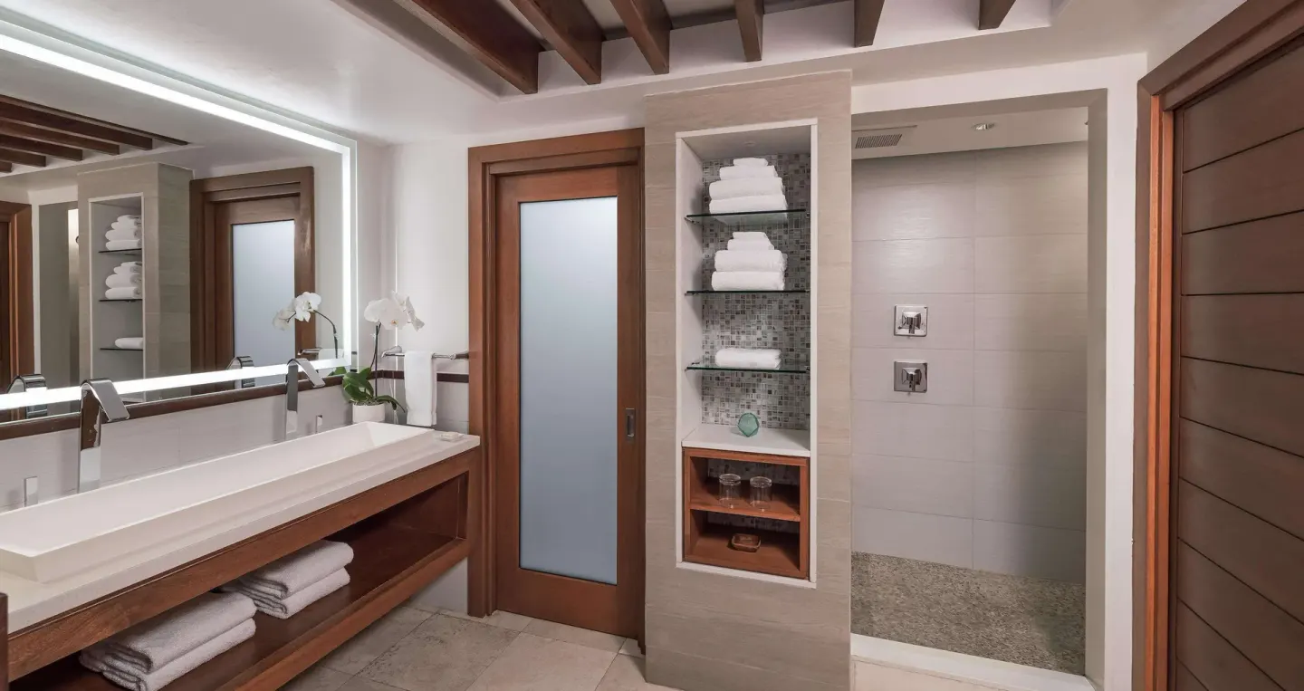 Longshore Luxury Room bathroom with double vanity and walk-in shower at Sandals Negril.