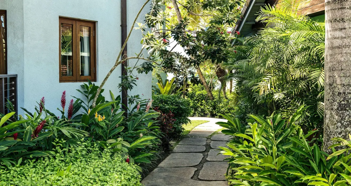 Garden walkway outside the Longshore Luxury Room buildings at Sandals Negril.