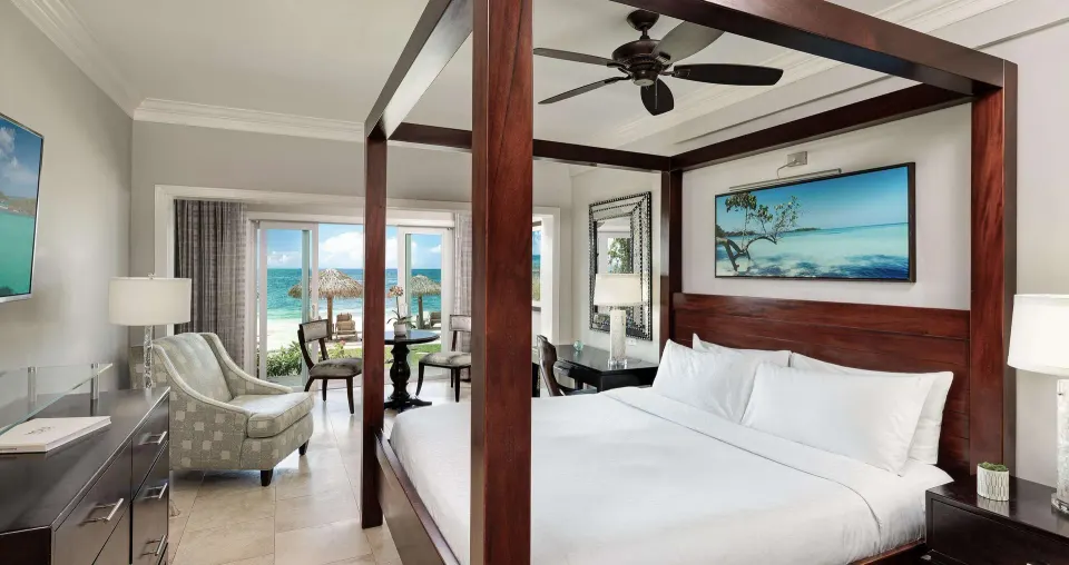 King four-poster bed in a Paradise Beachfront Walkout Club Level Room at Sandals Negril.