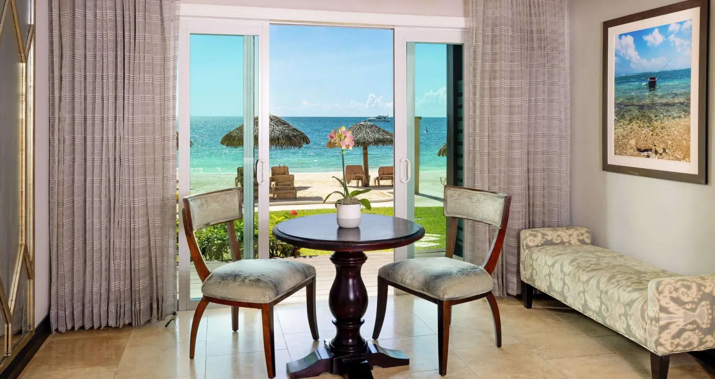 Beachfront seating area in a Paradise Beachfront Walkout Club Level Room at Sandals Negril.