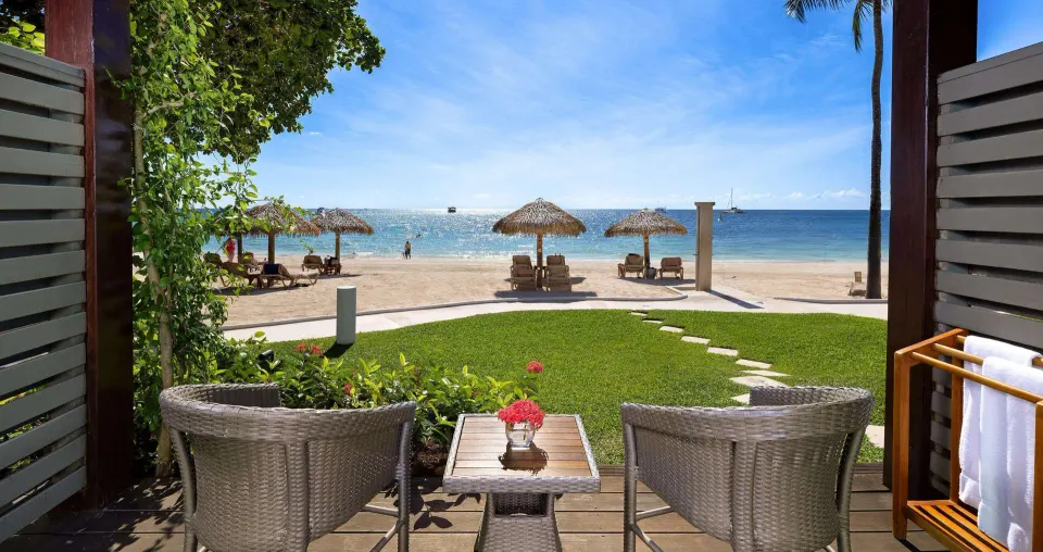 Walkout patio with beach view from a Paradise Beachfront Walkout Club Level Room at Sandals Negril.