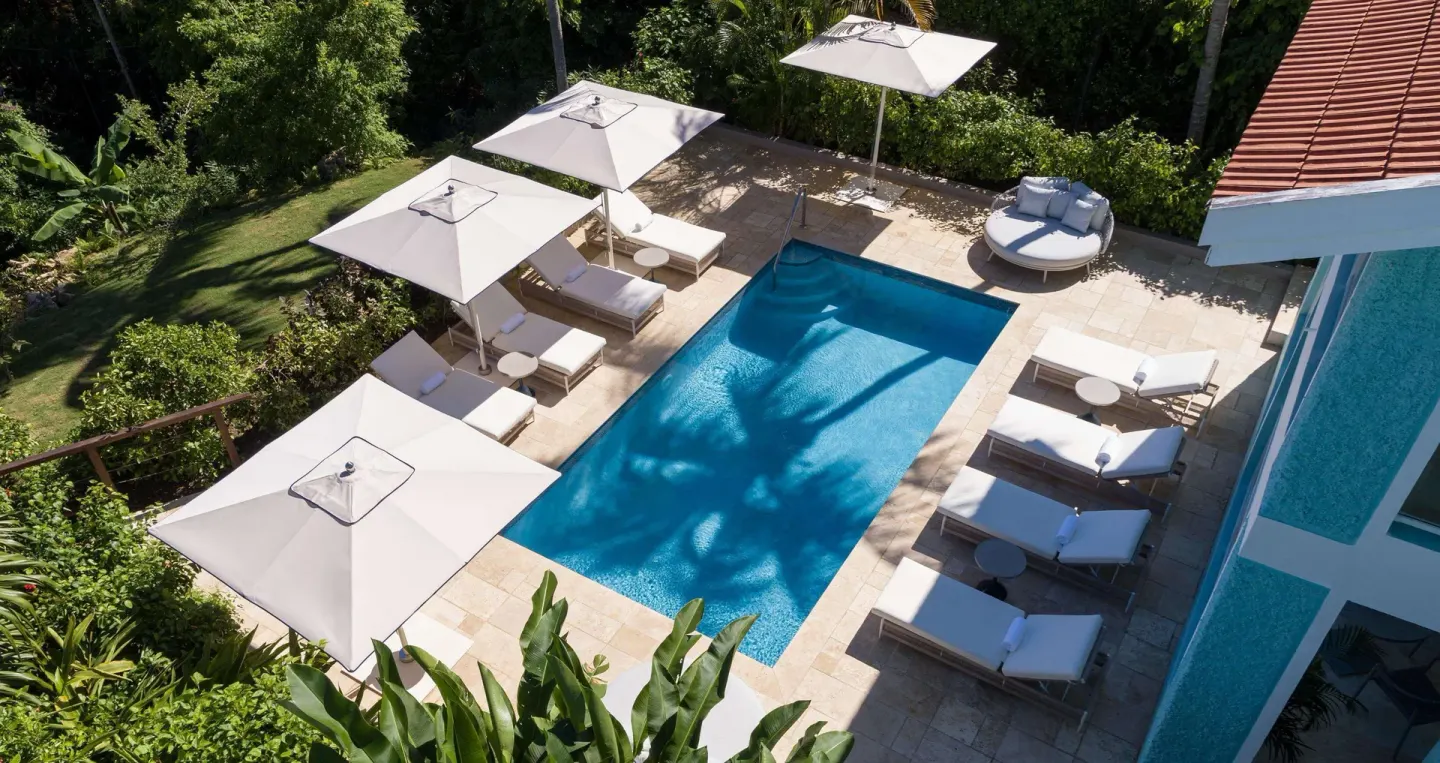 Overhead view of a private pool terrace with loungers at Sandals Ochi.