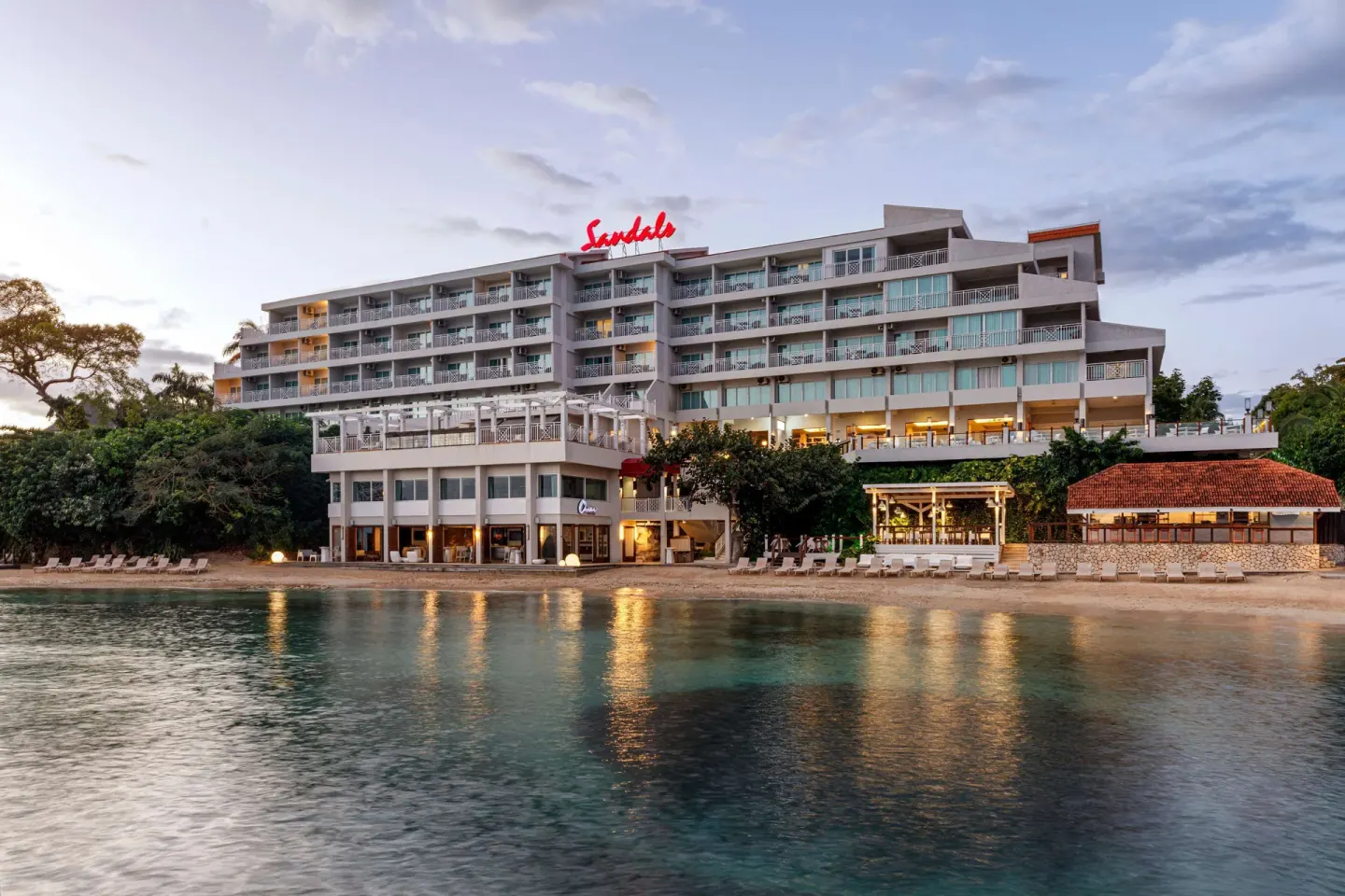Riviera beachfront building with balconies beside the water at Sandals Ochi.