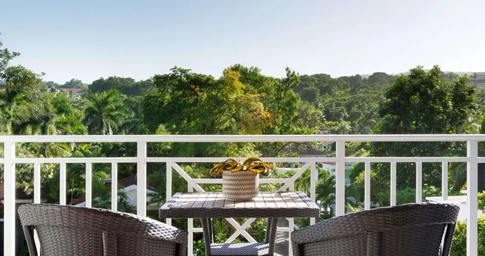 Furnished balcony with garden view at Sandals Ochi.