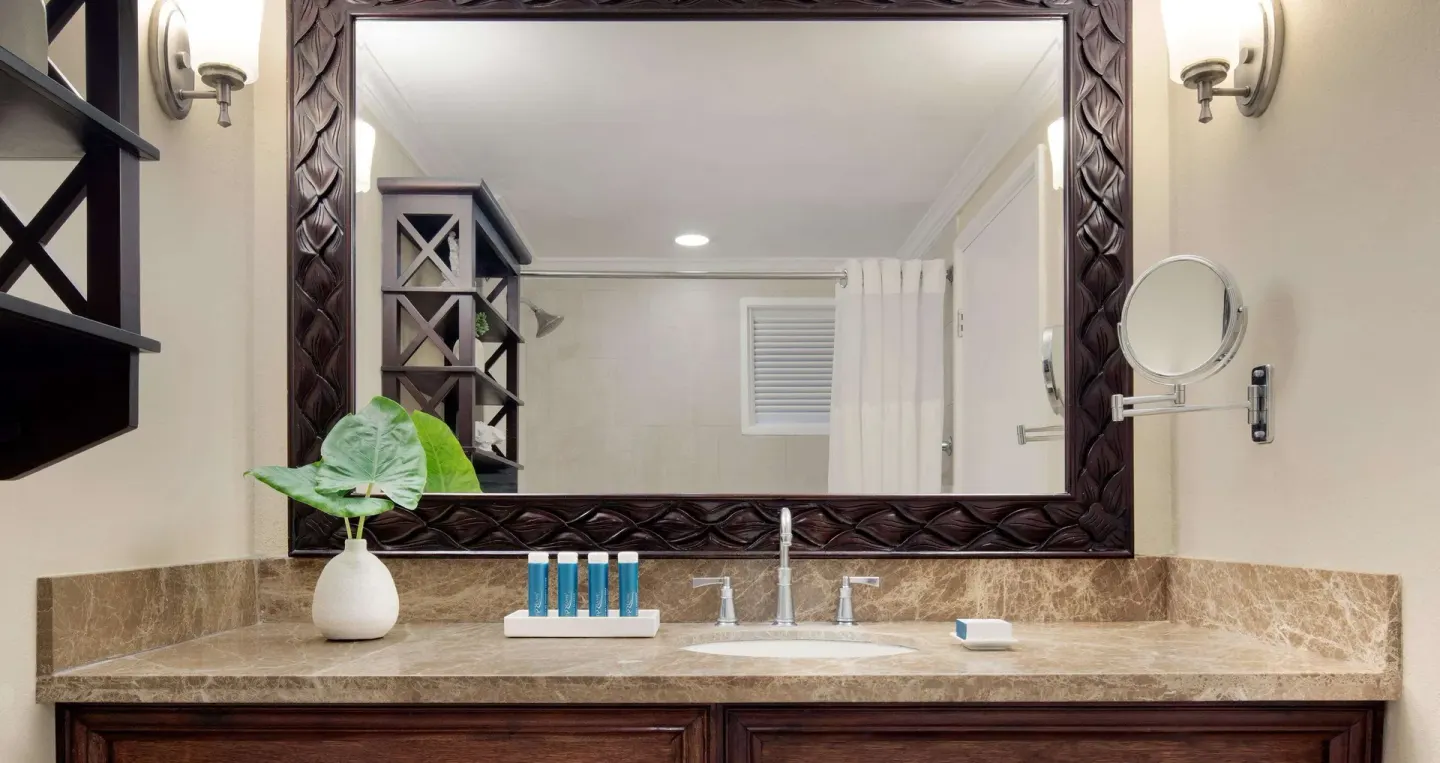 Bathroom vanity in a Honeymoon Cottage Garden View room at Sandals Ochi.