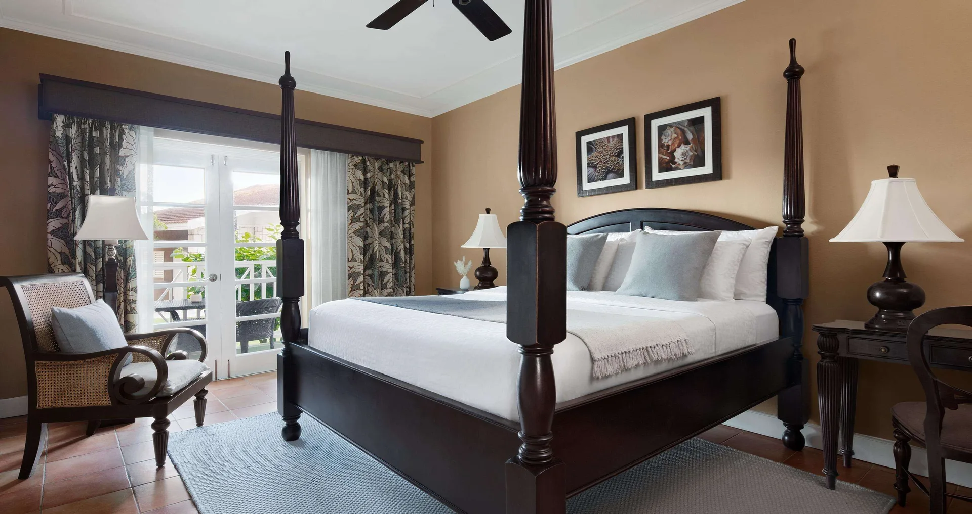 Four-poster king bed in a Honeymoon Cottage Garden View room at Sandals Ochi.