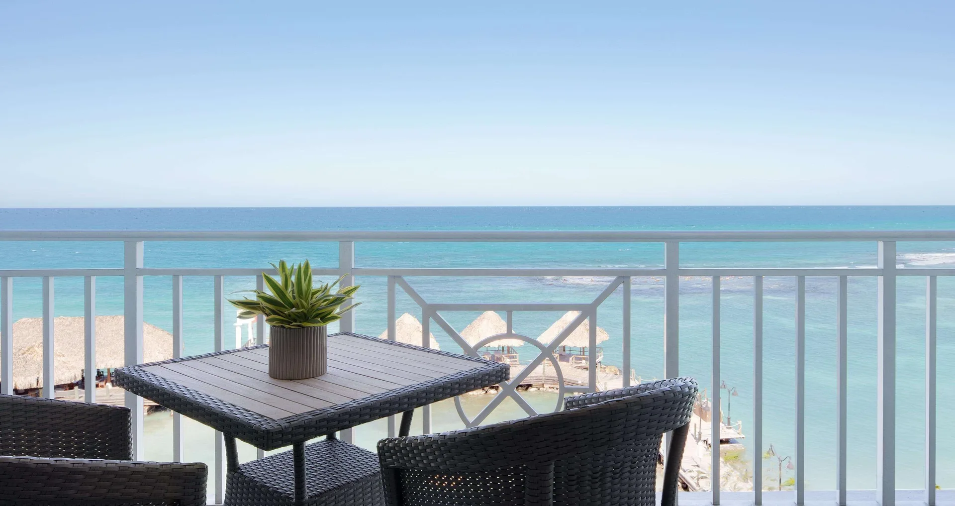 Ocean-view balcony seating for a Honeymoon Room at Sandals Ochi.