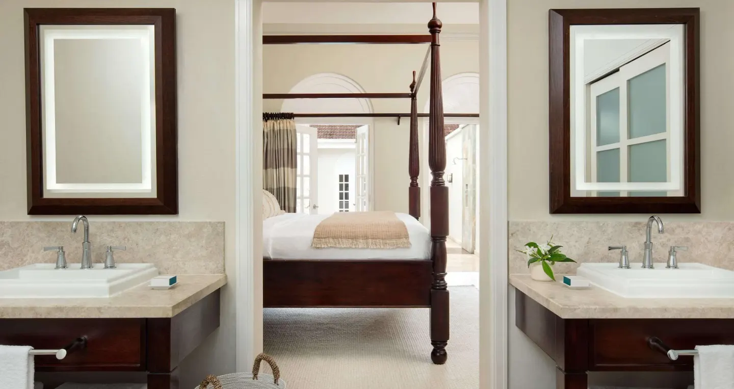 Double vanity bathroom with bedroom view in the Honeymoon Villa at Sandals Ochi.