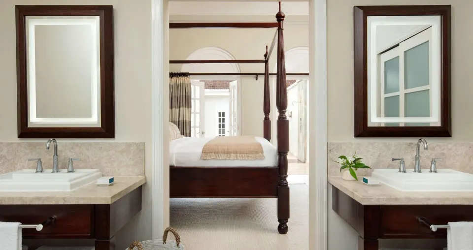 Double vanity bathroom with bedroom view in the Honeymoon Villa at Sandals Ochi.